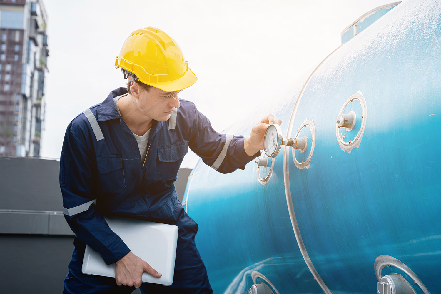 engineer checking gauge on tank