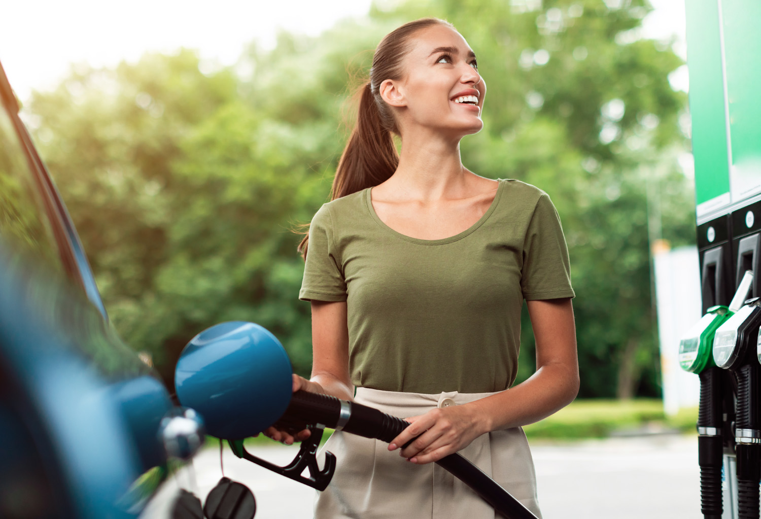 Lady Refilling Automobile With Fuel At Petrol Station Standing Outside