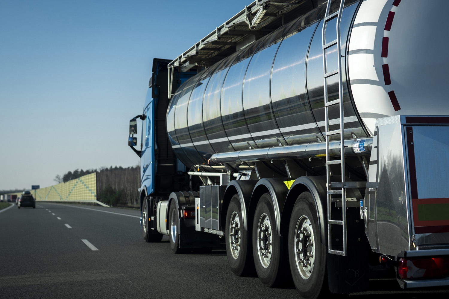 Long vehicle truck with tank trailer on a highway.