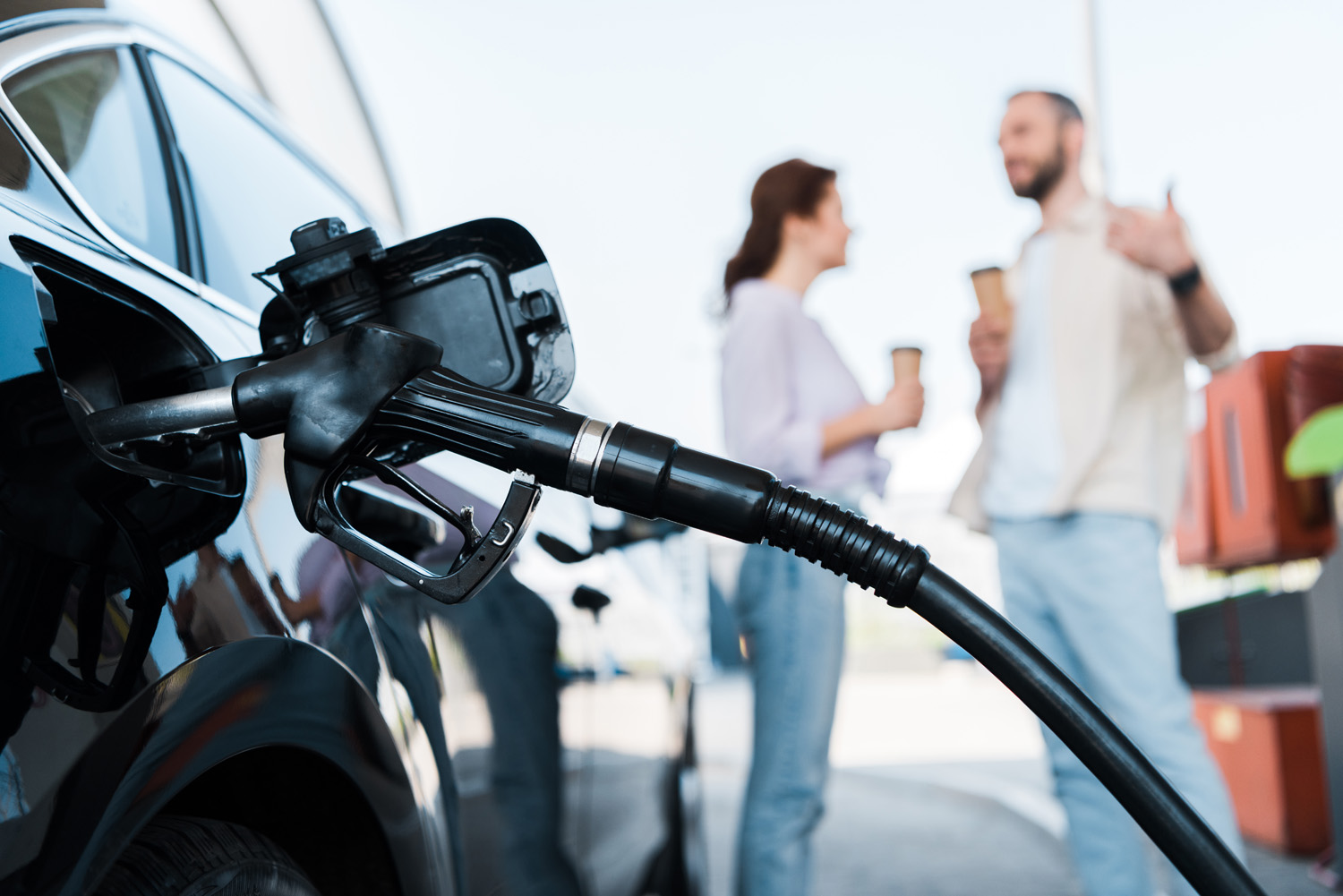 selective focus of black automobile refueling at gas station