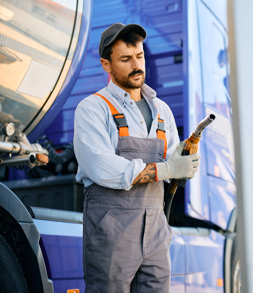 worker holding gasoline spout