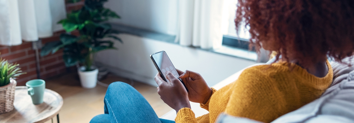 woman on couch using phone